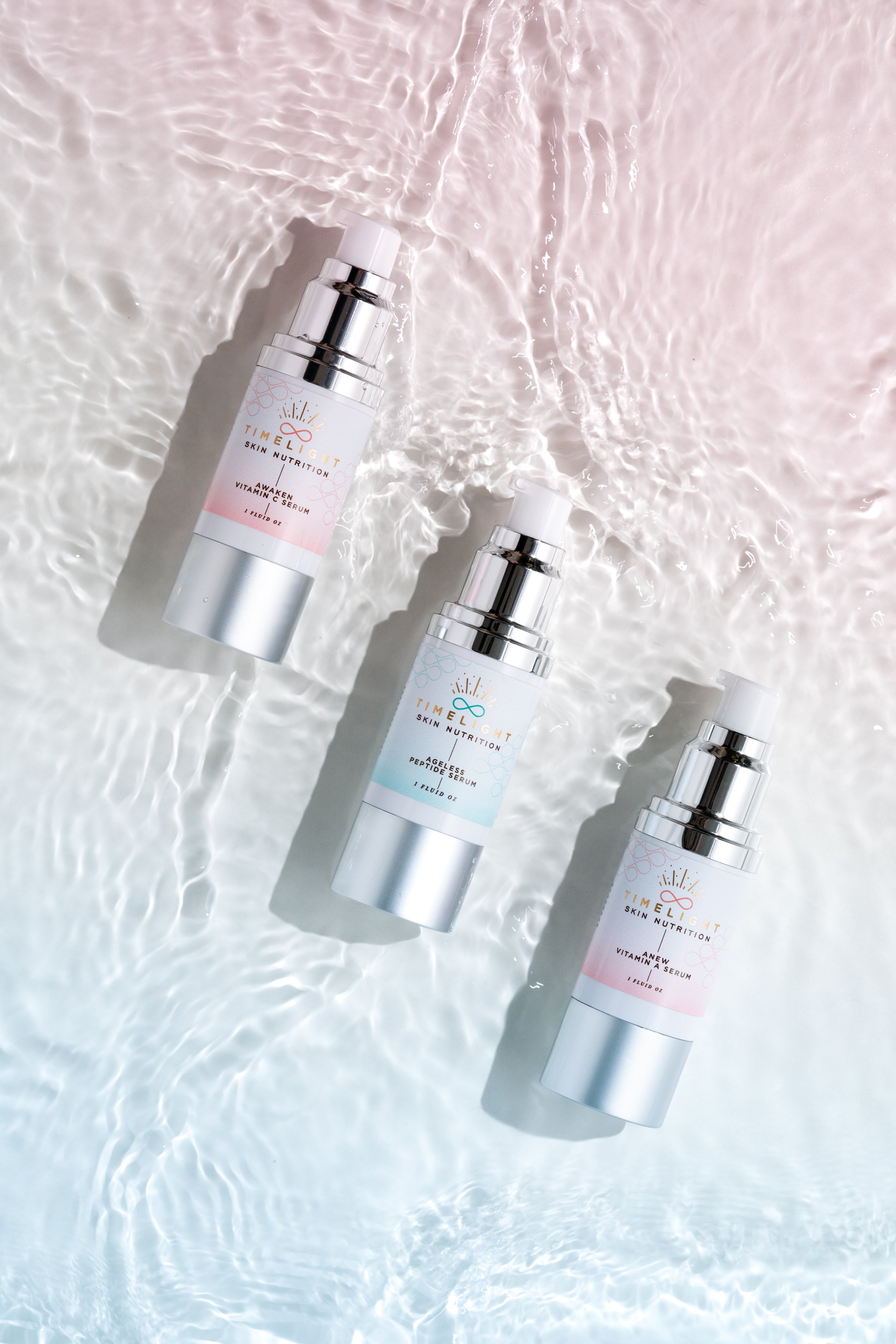 "Immerse Yourself in Radiant Skin: The Trinity of Serums by TimeLight Skin Nutrition, featuring the Electrolyte, Retinaldehyde Slow Release Vitamin A, and Argireline Peptide formulas, floating serenely in a pool of crystal-clear water."